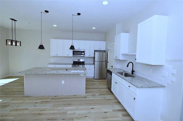 1 Fanshawe Ln, Palm Coast, FL 32137 - kitchen featuring white cabinetry, a center island, appliances with stainless steel finishes, and a sink