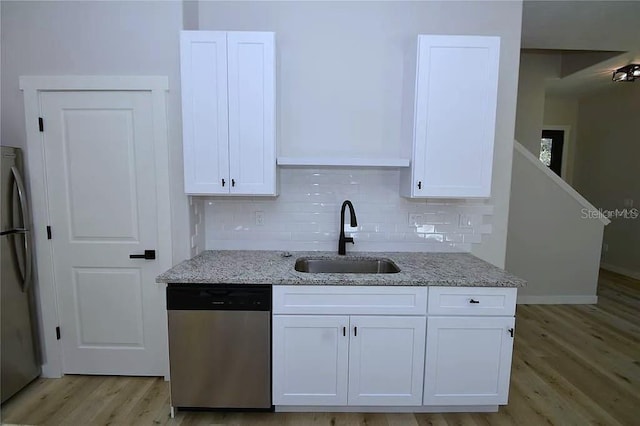 1 Fanshawe Ln, Palm Coast, FL 32137 - kitchen with light stone countertops, a sink, stainless steel appliances, light wood-style flooring, and white cabinetry
