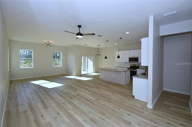 1 Fanshawe Ln, Palm Coast, FL 32137 - kitchen with white cabinets, visible vents, stainless steel appliances, a kitchen island, and baseboards