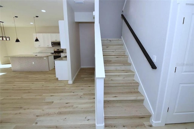 1 Fanshawe Ln, Palm Coast, FL 32137 - stairway featuring baseboards, recessed lighting, wood finished floors, and visible vents
