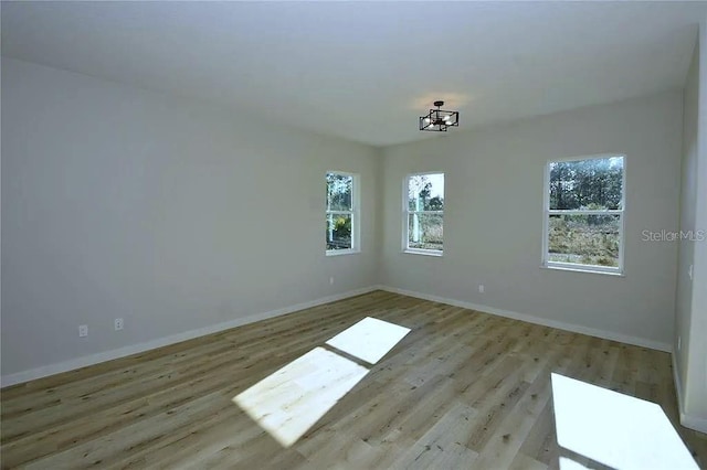 1 Fanshawe Ln, Palm Coast, FL 32137 - unfurnished room featuring a wealth of natural light, wood finished floors, and baseboards
