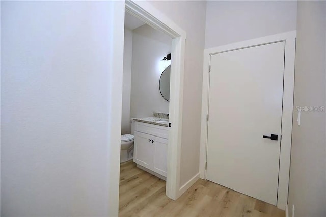 1 Fanshawe Ln, Palm Coast, FL 32137 - half bathroom featuring toilet, vanity, and wood finished floors