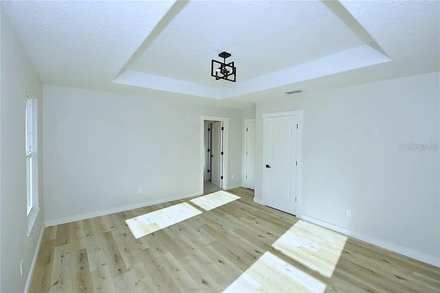1 Fanshawe Ln, Palm Coast, FL 32137 - interior space featuring light wood-style floors, a tray ceiling, and baseboards