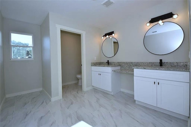 1 Fanshawe Ln, Palm Coast, FL 32137 - full bathroom with two vanities, visible vents, toilet, and marble finish floor