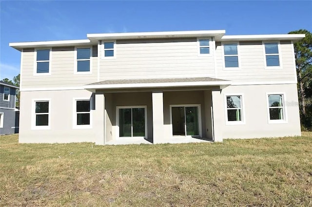 1 Fanshawe Ln, Palm Coast, FL 32137 - back of property with a lawn and stucco siding