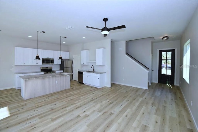 1 Fanshawe Ln, Palm Coast, FL 32137 - kitchen with a center island, stainless steel appliances, light wood-style flooring, and a sink