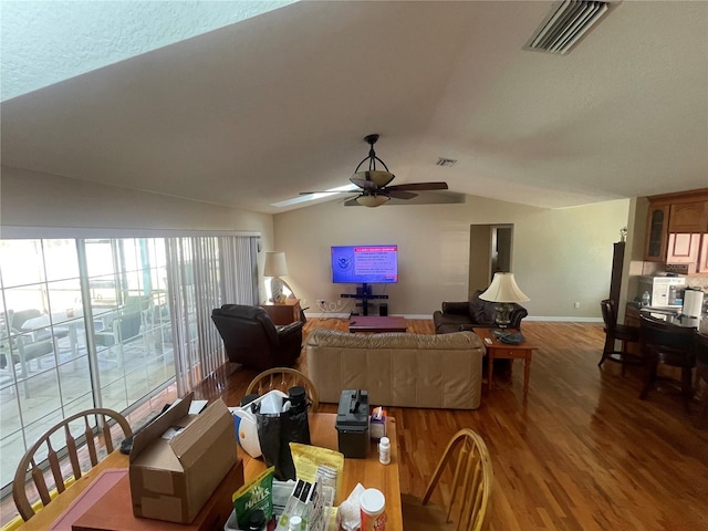 1501 Lambert Ave, Flagler Beach, FL 32136 - living area featuring vaulted ceiling, wood finished floors, ceiling fan, and baseboards