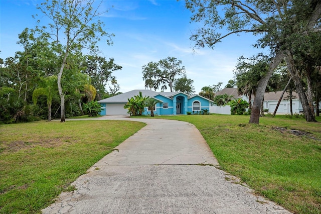 1501 Lambert Ave, Flagler Beach, FL 32136 - ranch-style home featuring driveway, a front lawn, and a garage