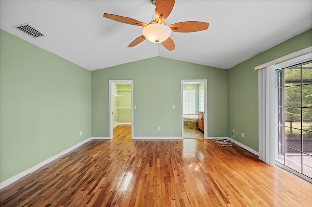 1501 Lambert Ave, Flagler Beach, FL 32136 - unfurnished bedroom featuring access to outside, wood finished floors, vaulted ceiling, multiple windows, and a spacious closet