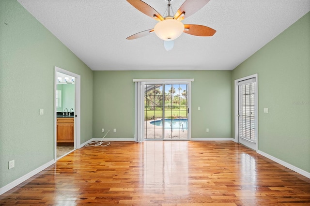 1501 Lambert Ave, Flagler Beach, FL 32136 - unfurnished room with wood finished floors, ceiling fan, lofted ceiling, and a textured ceiling