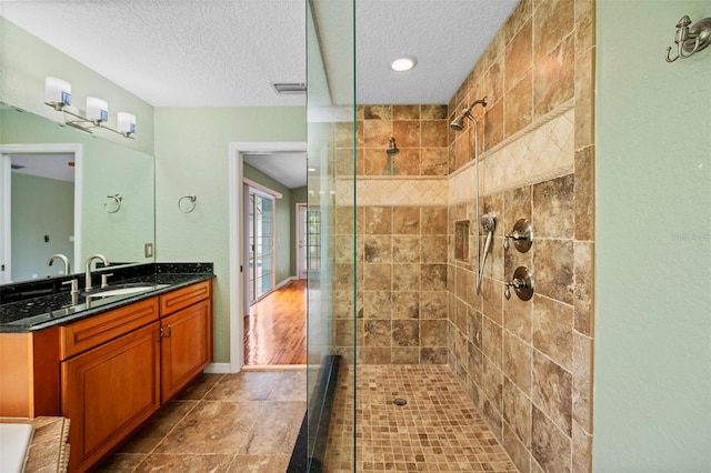1501 Lambert Ave, Flagler Beach, FL 32136 - full bath featuring tiled shower, vanity, and a textured ceiling
