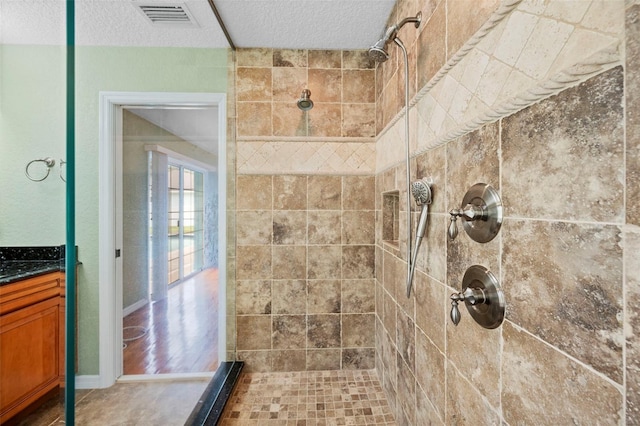 1501 Lambert Ave, Flagler Beach, FL 32136 - full bathroom featuring tiled shower, vanity, and a textured ceiling