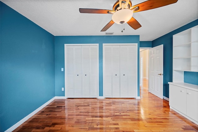 1501 Lambert Ave, Flagler Beach, FL 32136 - unfurnished bedroom with two closets, light wood-type flooring, and ceiling fan