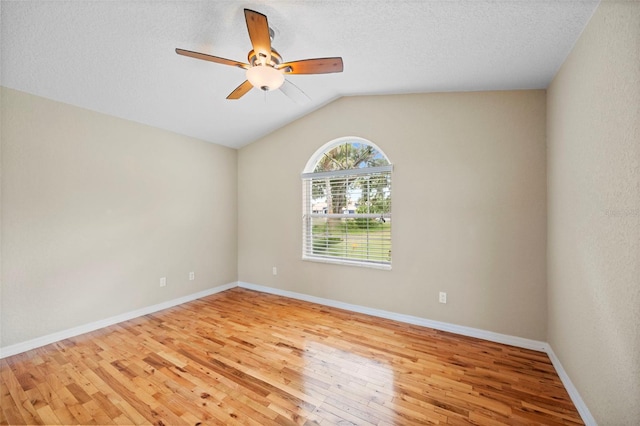 1501 Lambert Ave, Flagler Beach, FL 32136 - empty room featuring light wood-style floors, ceiling fan, vaulted ceiling, and a textured ceiling