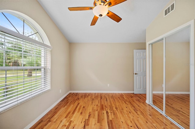 1501 Lambert Ave, Flagler Beach, FL 32136 - unfurnished bedroom with light wood-style flooring, a closet, vaulted ceiling, and a ceiling fan