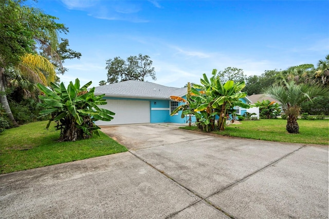 1501 Lambert Ave, Flagler Beach, FL 32136 - view of front of property featuring a garage, a front yard, driveway, and stucco siding