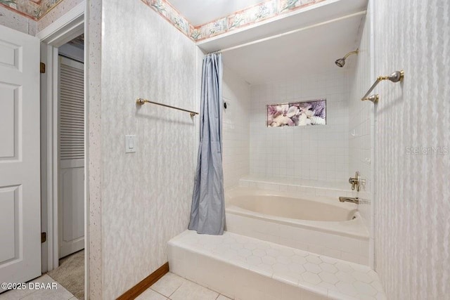 full bath featuring shower / bath combo with shower curtain and tile patterned flooring