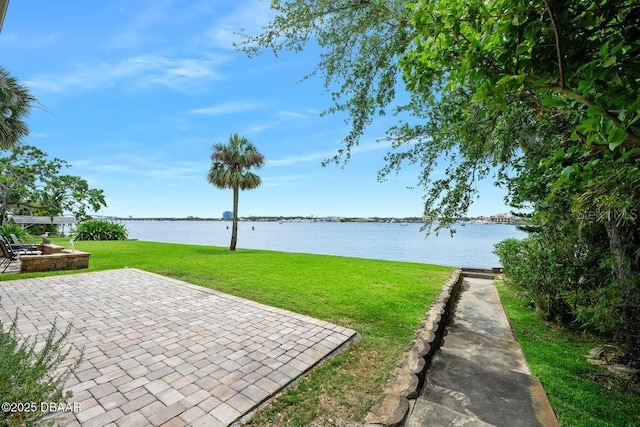 view of yard featuring a patio and a water view