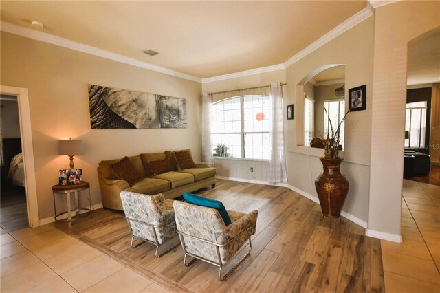 5 Baltimore Ln, Palm Coast, FL 32137 - living area with arched walkways, wood finished floors, ornamental molding, baseboards, and visible vents