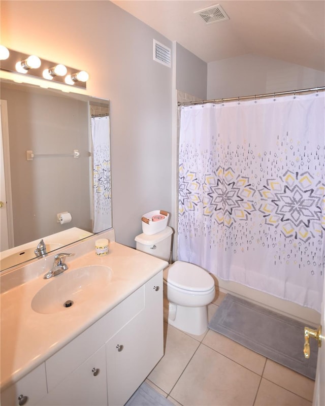 5 Baltimore Ln, Palm Coast, FL 32137 - full bath with tile patterned floors, toilet, vanity, visible vents, and lofted ceiling