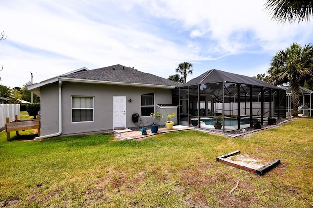 5 Baltimore Ln, Palm Coast, FL 32137 - back of property with stucco siding, roof with shingles, a yard, and a fenced in pool