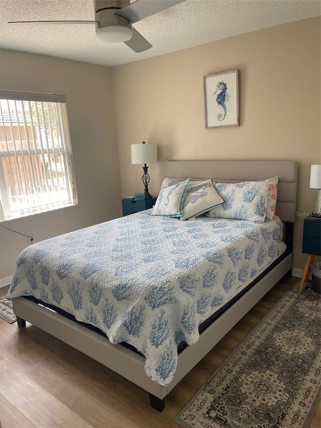 161 Bayside Dr, Palm Coast, FL 32137 - bedroom featuring wood finished floors, ceiling fan, and a textured ceiling
