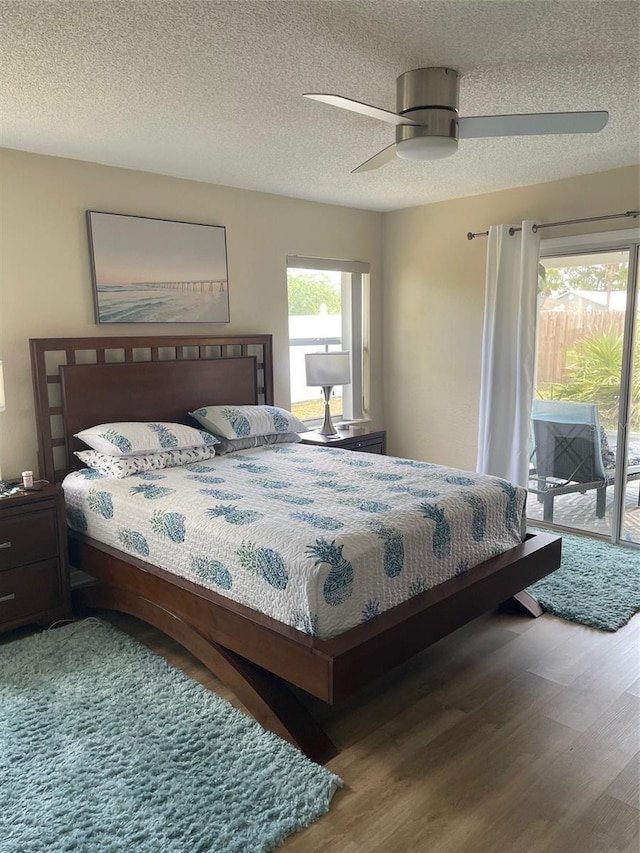 161 Bayside Dr, Palm Coast, FL 32137 - bedroom with access to outside, wood finished floors, a textured ceiling, and ceiling fan