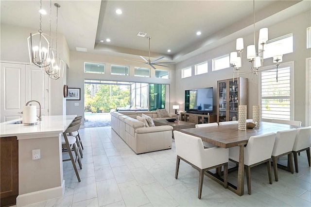628 Mahogany Run, Palm Coast, FL 32137 - dining room with recessed lighting, marble finish floor, ceiling fan with notable chandelier, visible vents, and a tray ceiling