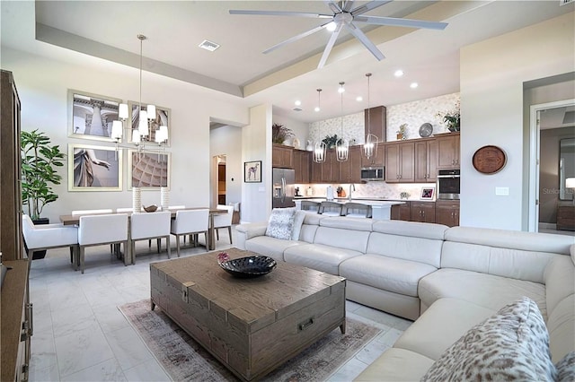 628 Mahogany Run, Palm Coast, FL 32137 - living area with recessed lighting, ceiling fan, marble finish floor, visible vents, and a towering ceiling