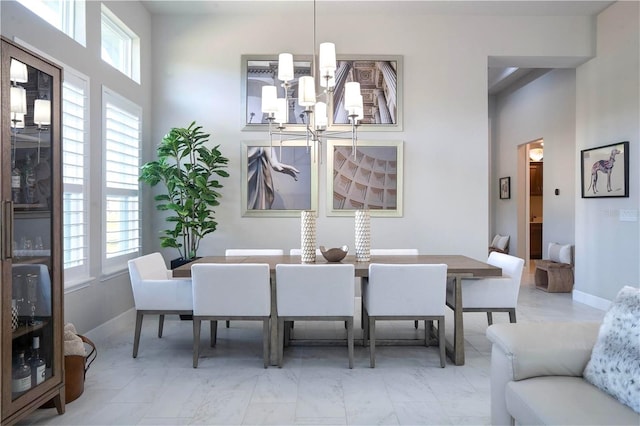 628 Mahogany Run, Palm Coast, FL 32137 - dining space featuring a chandelier and marble finish floor