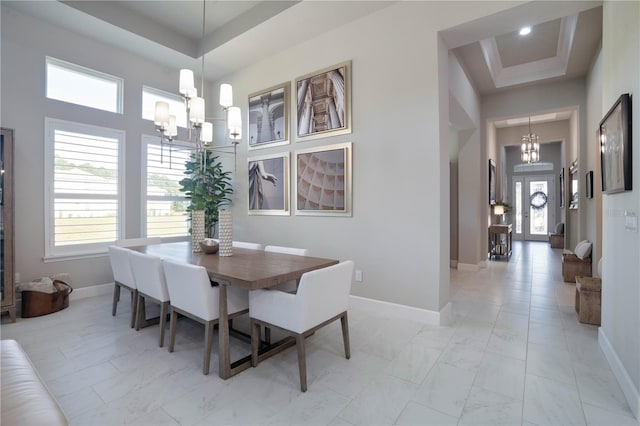 628 Mahogany Run, Palm Coast, FL 32137 - dining space with a notable chandelier, plenty of natural light, and a towering ceiling