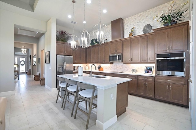 628 Mahogany Run, Palm Coast, FL 32137 - kitchen featuring an inviting chandelier, a sink, stainless steel appliances, marble finish floor, and visible vents