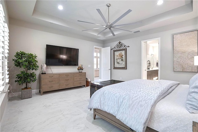 628 Mahogany Run, Palm Coast, FL 32137 - bedroom with visible vents, connected bathroom, recessed lighting, and a tray ceiling