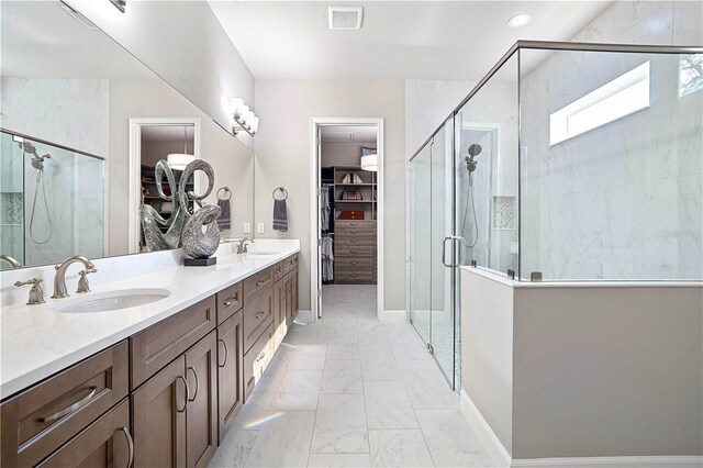 628 Mahogany Run, Palm Coast, FL 32137 - full bathroom with a stall shower, a sink, a spacious closet, and visible vents