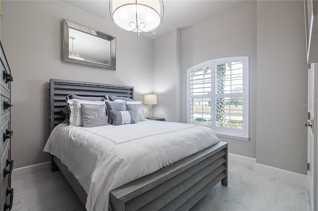 628 Mahogany Run, Palm Coast, FL 32137 - bedroom with marble finish floor, a notable chandelier, and baseboards