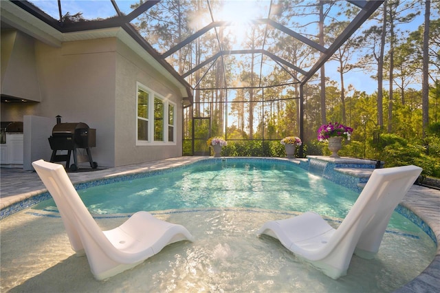 628 Mahogany Run, Palm Coast, FL 32137 - outdoor pool with glass enclosure, area for grilling, and a patio area