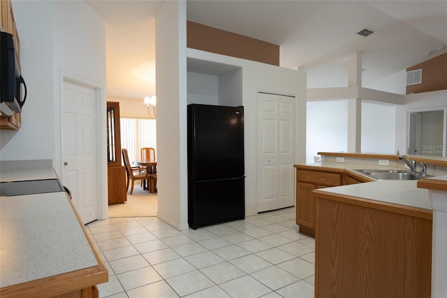 kitchen featuring a sink, a chandelier, light tile patterned flooring, black appliances, and visible vents