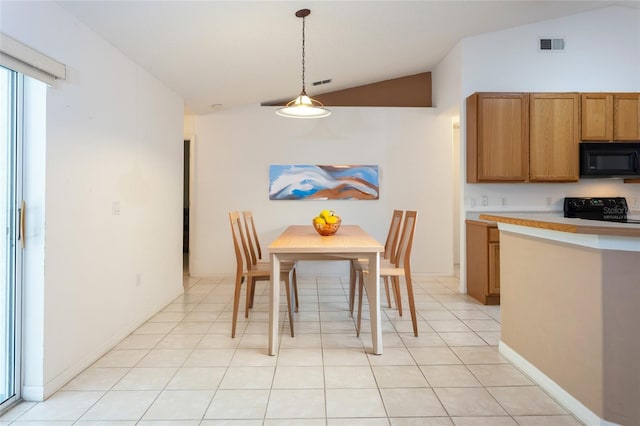 dining space featuring visible vents, light tile patterned floors, and vaulted ceiling