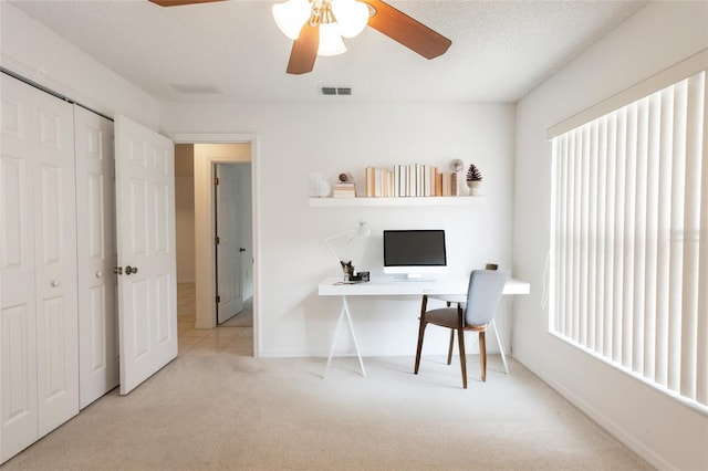 carpeted office featuring visible vents, ceiling fan, and baseboards