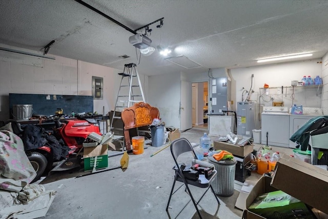 garage with heating unit, water heater, washing machine and clothes dryer, a garage door opener, and electric panel