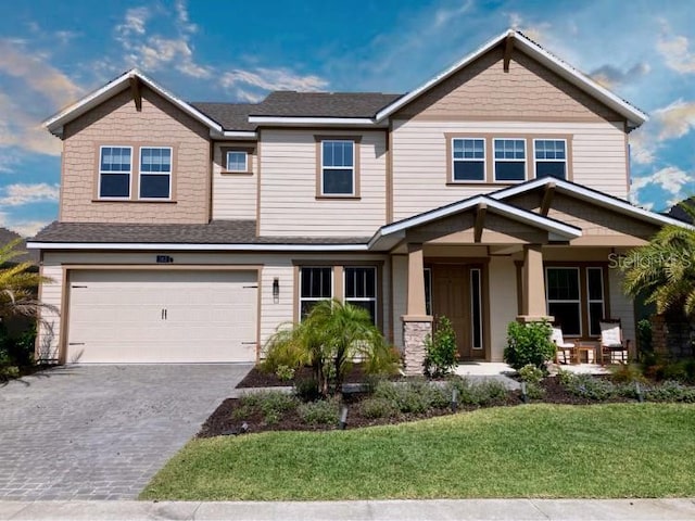382 Aquamarine Way, Daytona Beach, FL 32124 - craftsman-style house featuring a garage, a porch, a front lawn, and driveway