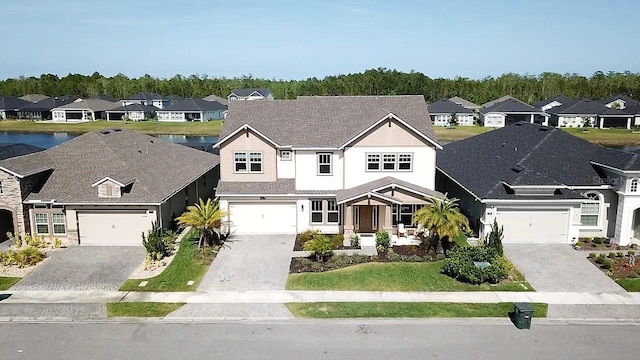 382 Aquamarine Way, Daytona Beach, FL 32124 - traditional home with driveway, a water view, stucco siding, and a residential view
