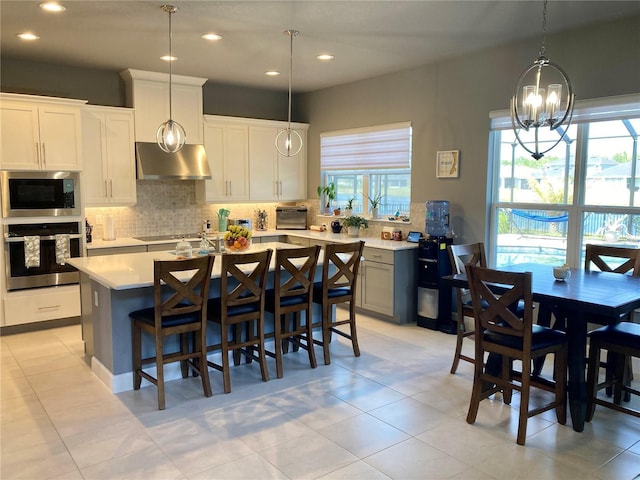 382 Aquamarine Way, Daytona Beach, FL 32124 - kitchen with stainless steel appliances, a wealth of natural light, light countertops, backsplash, and range hood