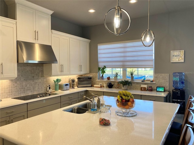 382 Aquamarine Way, Daytona Beach, FL 32124 - kitchen with tasteful backsplash, an island with sink, black electric stovetop, under cabinet range hood, and a sink