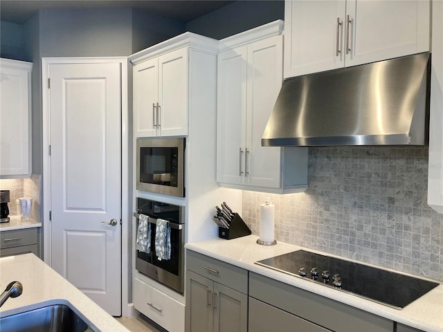382 Aquamarine Way, Daytona Beach, FL 32124 - kitchen featuring built in microwave, under cabinet range hood, gray cabinets, black electric stovetop, and oven