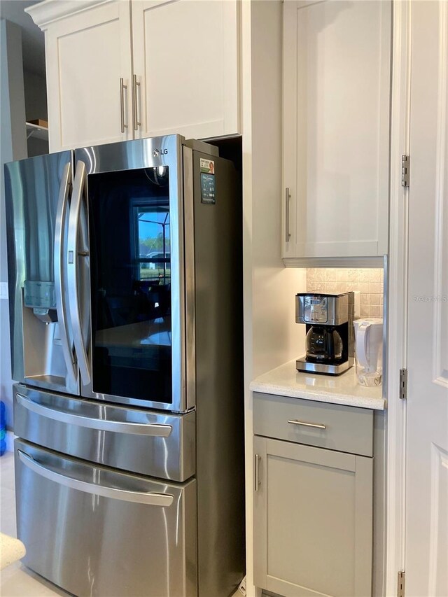 382 Aquamarine Way, Daytona Beach, FL 32124 - kitchen featuring stainless steel fridge, gray cabinetry, tasteful backsplash, and light countertops