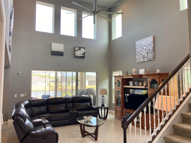 382 Aquamarine Way, Daytona Beach, FL 32124 - living area with a healthy amount of sunlight, stairway, a ceiling fan, and a high ceiling