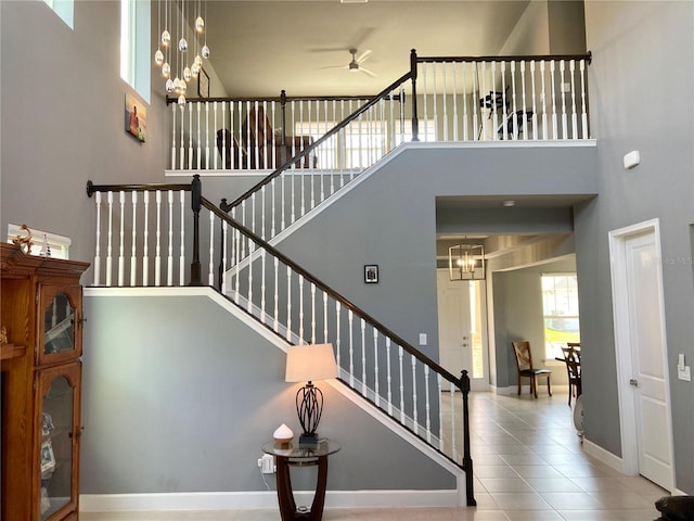 382 Aquamarine Way, Daytona Beach, FL 32124 - staircase featuring a high ceiling, baseboards, and ceiling fan with notable chandelier