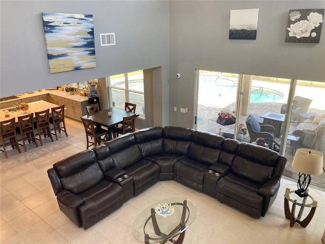 382 Aquamarine Way, Daytona Beach, FL 32124 - living room featuring light tile patterned flooring, visible vents, and a high ceiling