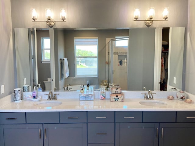 382 Aquamarine Way, Daytona Beach, FL 32124 - bathroom featuring toilet, a stall shower, double vanity, and a sink